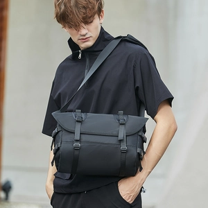 Men's black crossbody messenger bag in durable nylon with functional buckles and straps