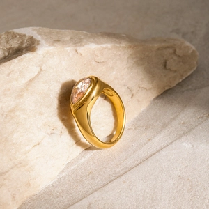 Macro detail of a gold 18k stainless steel ring with a large oval white zircon stone