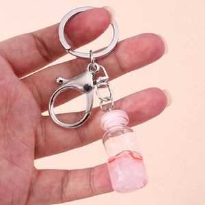 Detail of pink liquid wishing bottle keychain with silver metal lobster clasp and ring