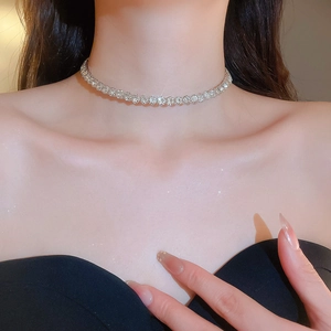 Close-up of a silver rhinestone necklace on a model showing sparkling crystal details
