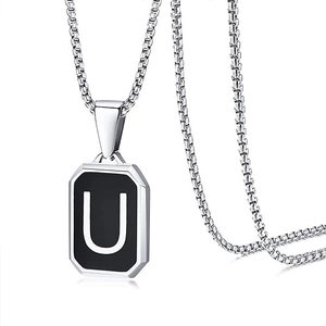 Close-up of black square stainless steel pendant necklace featuring the letter U