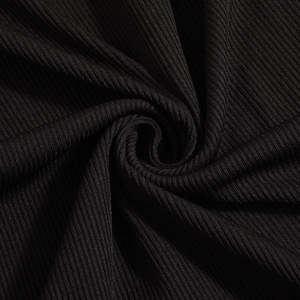 Close-up of black ribbed knit fabric showing detailed texture and soft drapery