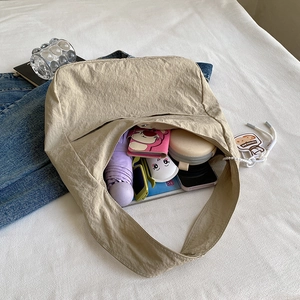 Minimalist beige pleated nylon tote bag with spacious interior for daily essentials