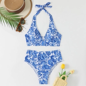 Blue paisley halter neck bikini set with high waist bottom on a beach themed flat lay