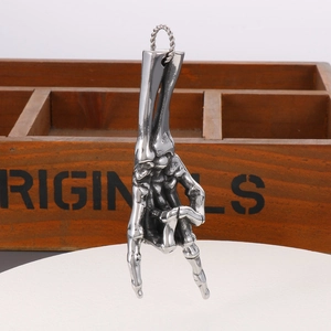 Detailed close-up of a rock gesture skeleton hand pendant with twisted metal ring texture