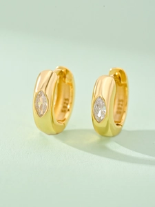 Macro shot of S925 silver gold-plated hoop earring with marquise-cut cubic zirconia