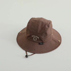 Detailed view of children's brown outdoor bucket hat with adjustable chin strap and embroidery