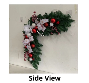 Side view of Christmas door corner swag with red and white balls and candy cane bow