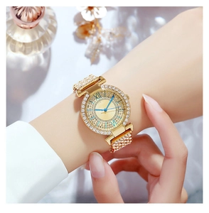 Close-up of elegant gold watch with rhinestone-studded bezel and blue hands on wrist