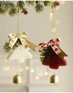 Detail of red and white flocked Christmas tree hanging ornaments with golden bells