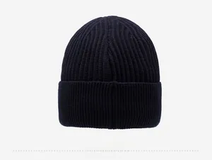 Detailed back view of a navy blue thick knitted beanie with a folded brim and ribbed texture
