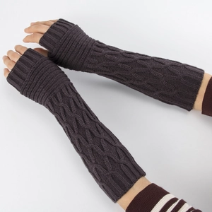 Detail of dark grey cable knit fingerless gloves showing long wrist warmer texture
