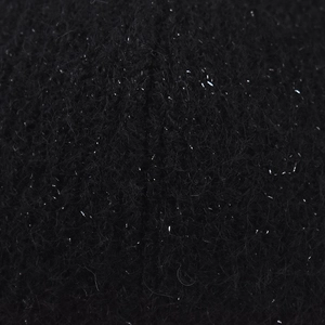 Macro detail of black knitted fabric with silver sparkling fibers and starry texture