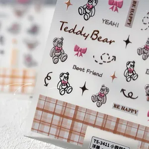 Macro detail of 5D embossed nail stickers featuring grey teddy bears and pink bows