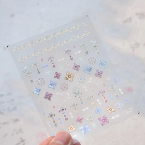 Detail of holographic relief nail stickers with elegant floral and European patterns