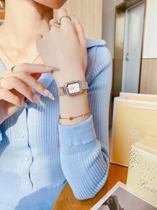 Detailed shot of a ladies' square watch with crystal bezel and mixed metal link strap