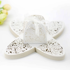 Laser-cut white wedding candy box with rose pattern and organza ribbon decoration