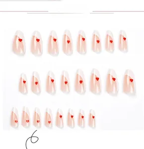 Detail view of 24pcs almond press-on nails with white French tips and red heart accents