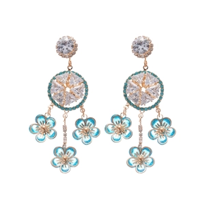 Elegant gold drop earrings with light blue flower charms and geometric zircon stones