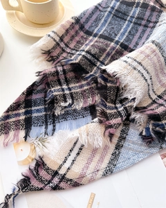Detail of soft plaid scarf with tassels in blue, purple, and beige woven fabric