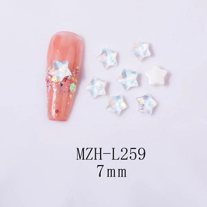 Macro shot of 7mm iridescent star nail art charms and application on pink glitter nails