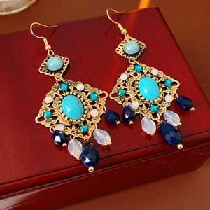 Detail of vintage bohemian tassel earrings with turquoise and opal effect beads