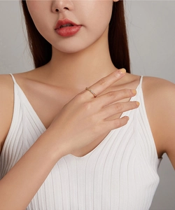 Close-up of a slender gold S925 silver ring paved with sparkling white cubic zirconia
