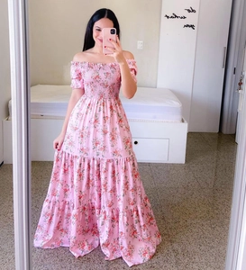 Detail of off-shoulder floral maxi dress with elastic smocked waist and tiered skirt layers