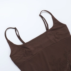 Detail shot of the rhinestone floral pattern on a dark brown bodycon dress fabric