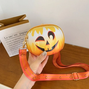 Detail of pumpkin crossbody bag with emoji face and printed nylon shoulder strap