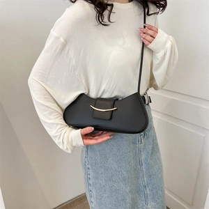 Minimalist black faux leather shoulder bag with stylish gold circular metal buckle design
