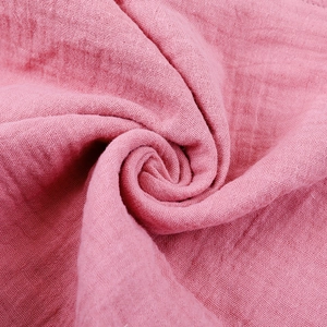 Macro shot of soft pink cotton gauze fabric texture for newborn soothing blanket
