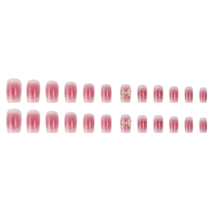 Pink and white gradient press-on nails with 3D bows and red heart patterns