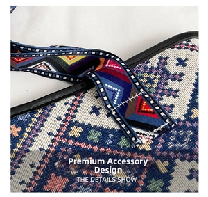 Detail showing ethnic jacquard fabric texture and black leather trim on a tote bag
