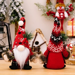 Christmas gnomes with knitted hats, candy cane and lantern in festive holiday setting