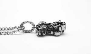 Detailed macro of a silver motorcycle engine pendant with industrial punk mechanical design