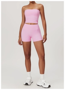 Detailed view of pink yoga set with high-waist shorts and tube top for fitness