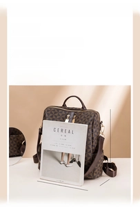 Detailed dimension guide for the brown geometric print backpack showing 34x31x14cm size