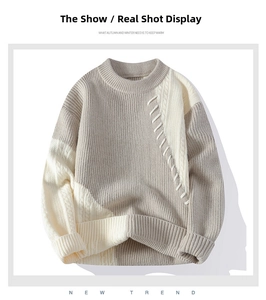 Detail des grau-weißen Strickpullovers mit grober Textur und gerippten Ärmelbündchen