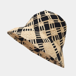 Close-up of black and beige woven pattern texture on a stylish straw bucket hat