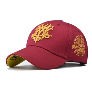 Detail of burgundy cotton baseball cap with gold 3D embroidery and side explorer patch