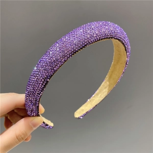 Detailed close-up of purple rhinestones and non-slip matte lining on a padded headband