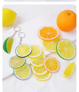 Close-up of realistic PVC lemon, orange and lime slices as creative keychain charms
