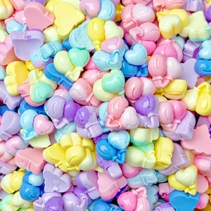 Macro shot of colorful resin balloon-shaped beads for DIY jewelry and nail art