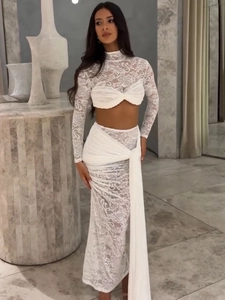 White lace two-piece set featuring long sleeve crop top and matching maxi skirt with ribbons