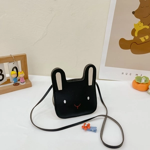 Detailed close-up of a black faux leather rabbit-shaped crossbody bag for children