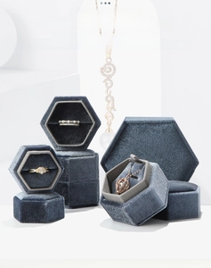 Macro detail of blue velvet hexagonal jewelry box on modern white geometric display