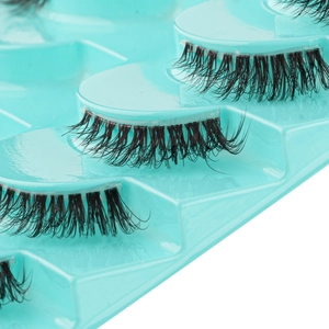 Close-up of 10 pairs natural thick black false eyelashes on blue tray display