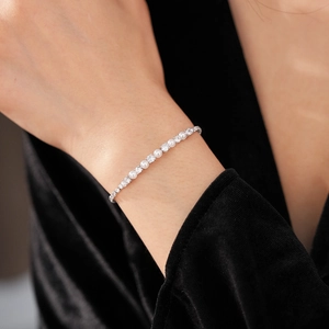Detail of elegant pearl and cubic zirconia tennis bracelet on a black velvet sleeve