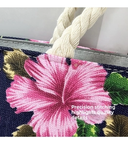 Close-up of floral canvas tote bag featuring precision stitching and braided rope handles
